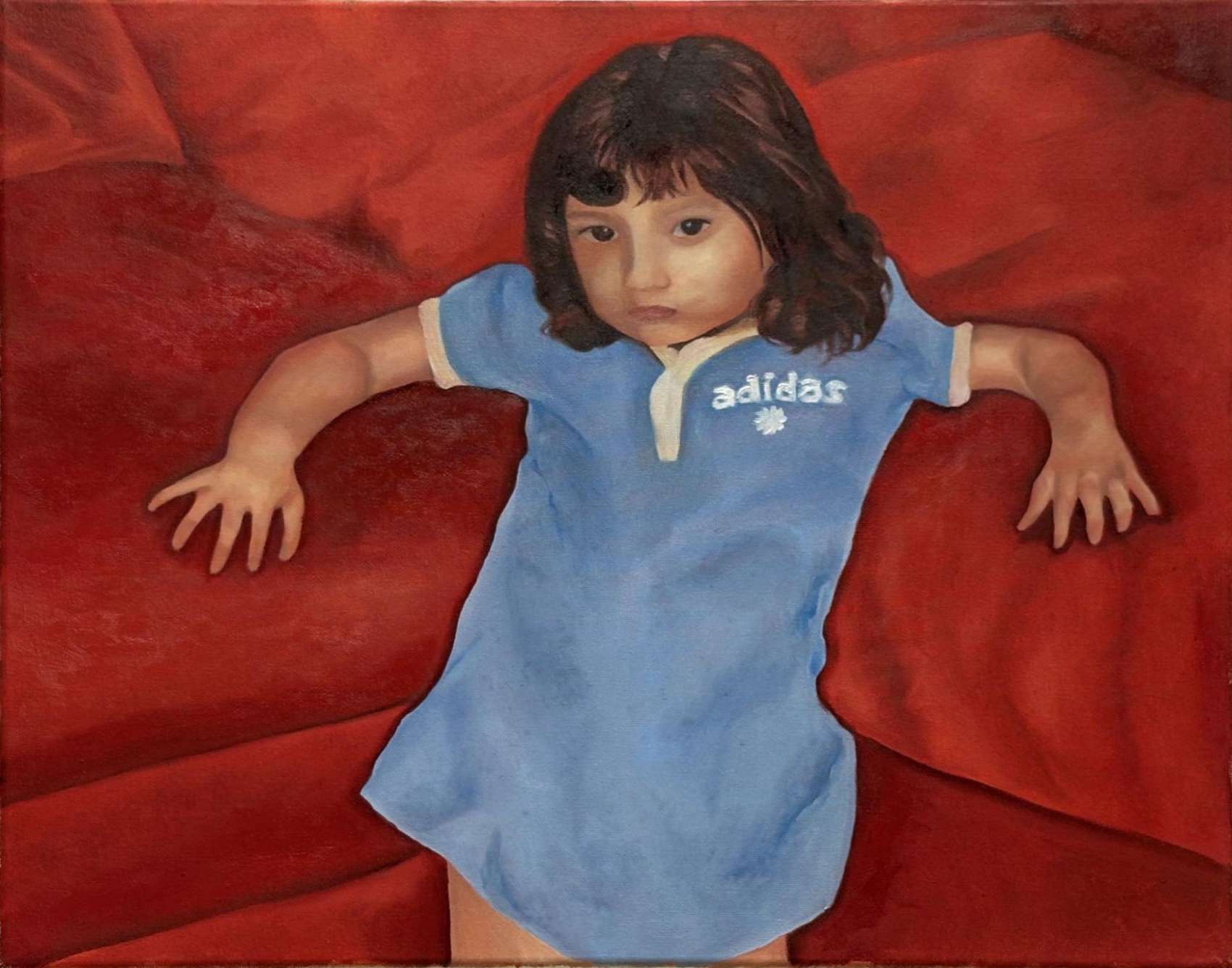 A young child in a blue shirt lying with arms outstretched across a deep red couch, painted from directly above.